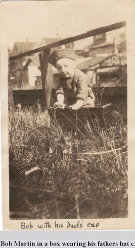 Bob Martin in a box wearing his fathers hat c. 1921