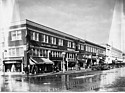 This photo shows both the Barnes building, (on the corner with the Drug store and hardware store in it), and the Lotus Building adjoining it with contiguous brick and terra cotta work.