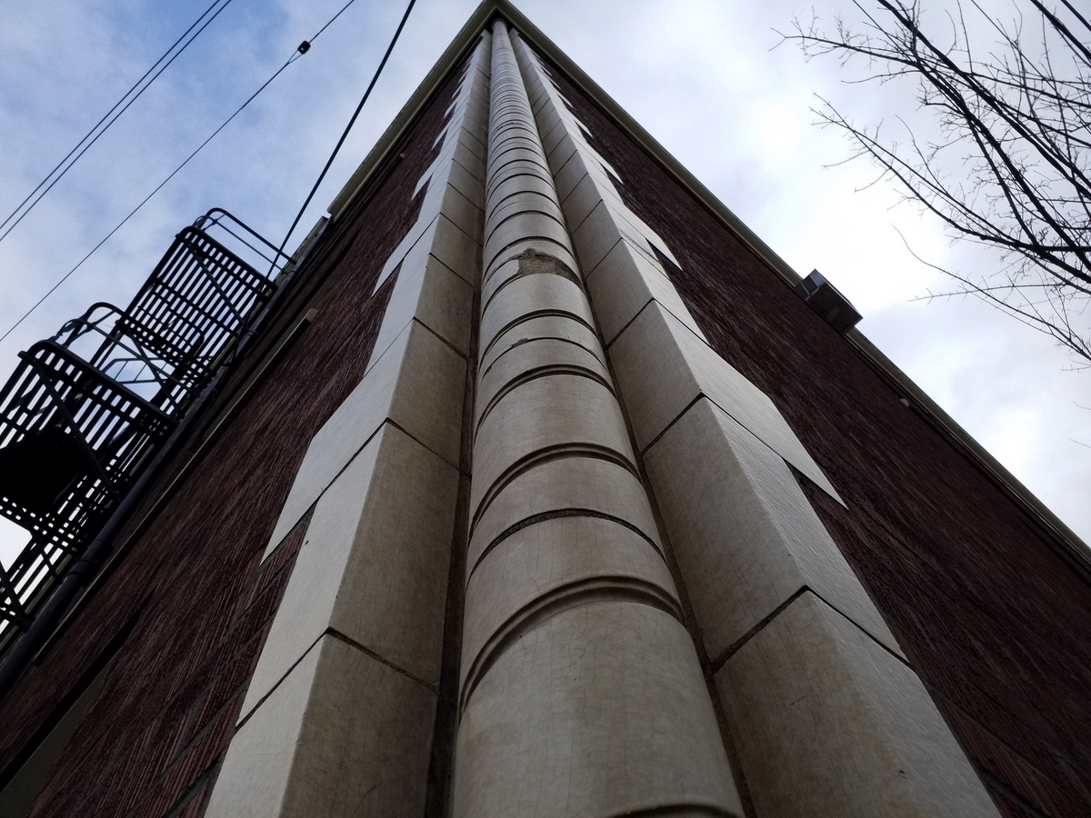 Photo taken Feb. 2018. Twisted column detail at the NW corner of the Empress Apartments Hotel.  Built in 1926 at 16th and Washington.  Current Address in 2017 is 1539-1541 W Burnside. Order #165 Glaze #22M in Leonard Martins order book for Columbia Terra Cotta Co.  The name of the hotel was for a period of time "Marquette Manor"