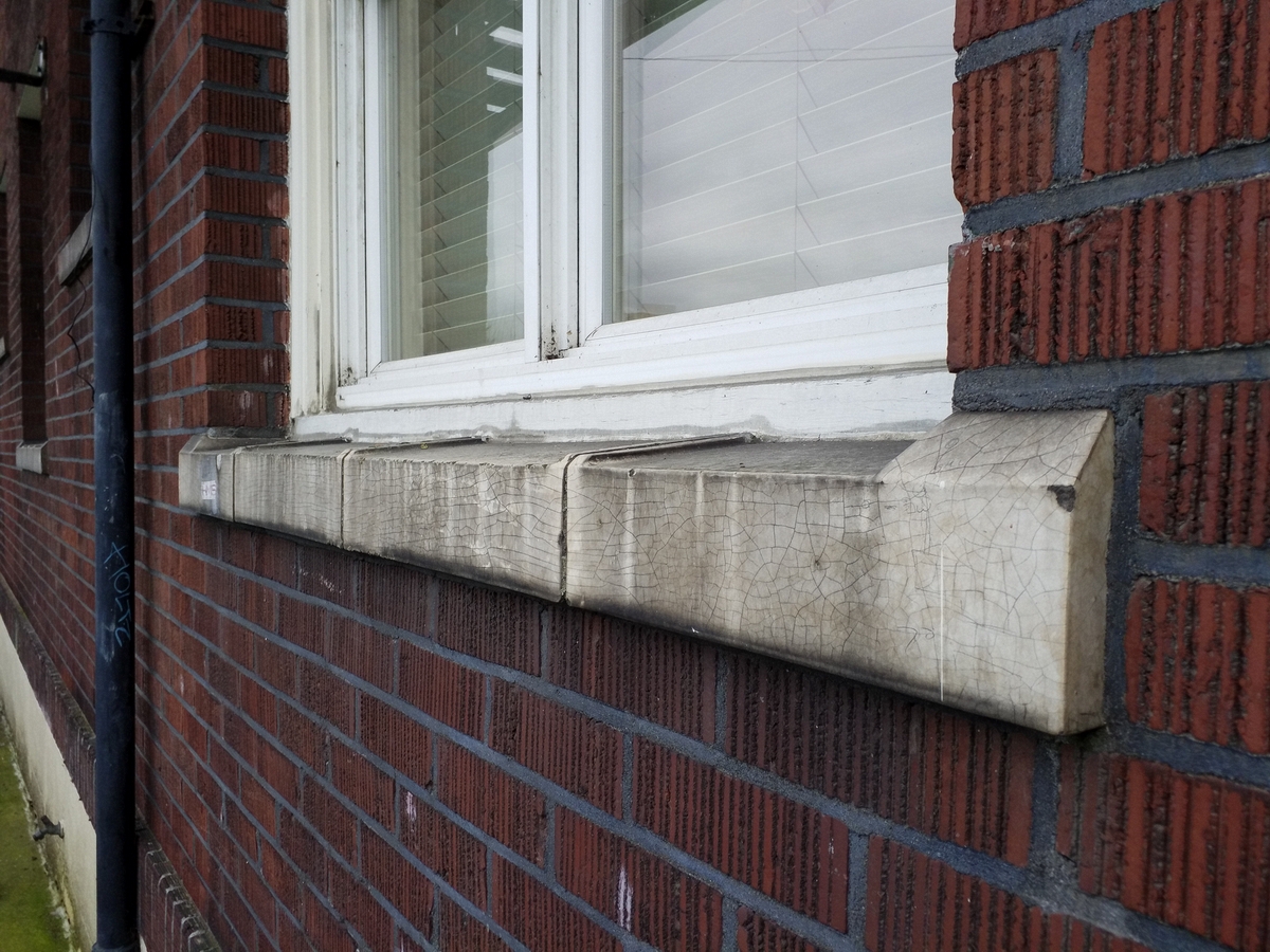 Photo taken Feb. 2018. Window sill on the west side of the Empress Apartments Hotel.  Built in 1926 at 16th and Washington.  Current Address in 2017 is 1539-1541 W Burnside. Order #165 Glaze #22M in Leonard Martins order book for Columbia Terra Cotta Co.  The name of the hotel was for a period of time "Marquette Manor"