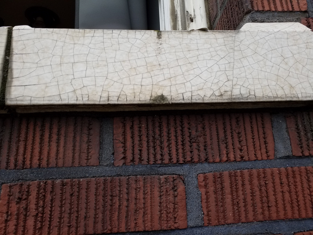 Photo taken Feb. 2018. Closeup of glazeed sill on the west side of the Empress Apartments Hotel.  Built in 1926 at 16th and Washington.  Current Address in 2017 is 1539-1541 W Burnside. Order #165 Glaze #22M in Leonard Martins order book for Columbia Terra Cotta Co.  The name of the hotel was for a period of time "Marquette Manor"