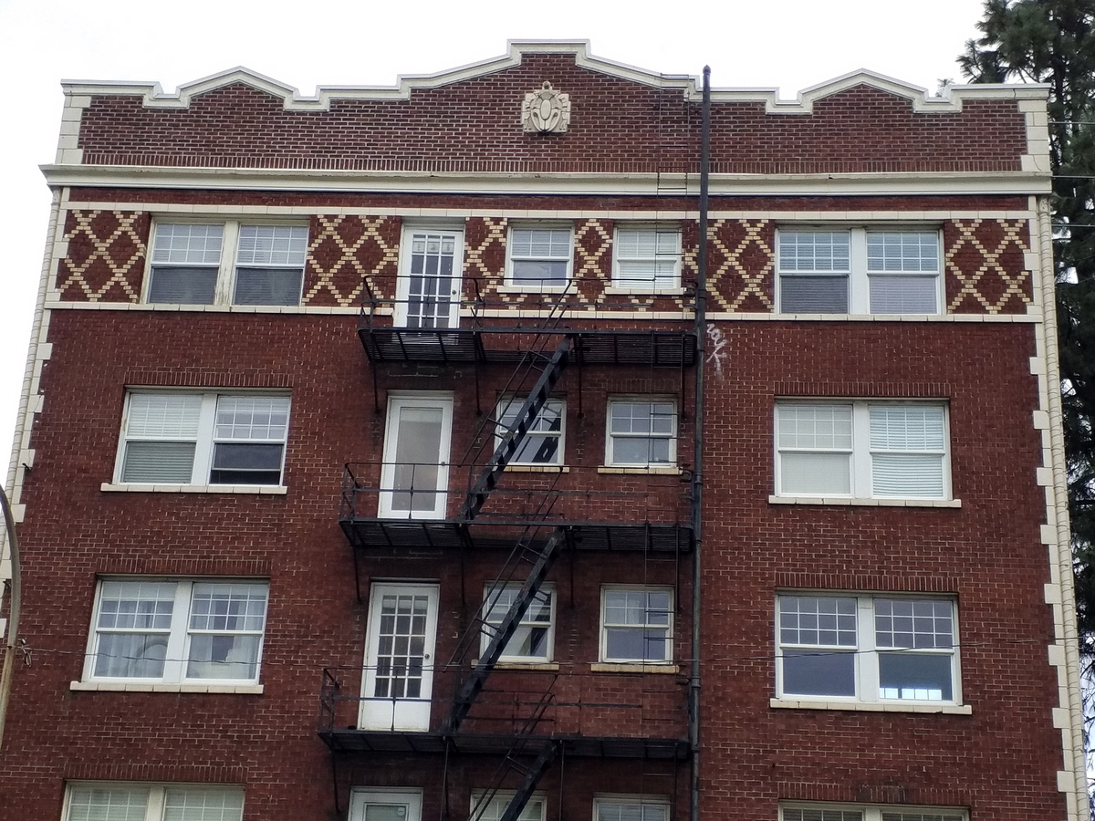 Photo taken Feb. 2018. South end of the Empress Apartments Hotel.  Built in 1926 at 16th and Washington.  Current Address in 2017 is 1539-1541 W Burnside. Order #165 Glaze #22M in Leonard Martins order book for Columbia Terra Cotta Co.  The name of the hotel was for a period of time "Marquette Manor"