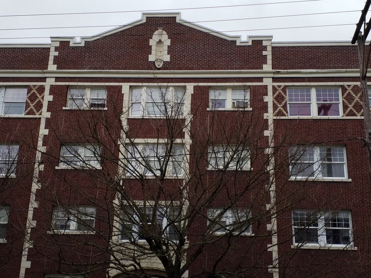 Photo taken Feb. 2018. West view upper detail of the Empress Apartments Hotel.  Built in 1926 at 16th and Washington.  Current Address in 2017 is 1539-1541 W Burnside. Order #165 Glaze #22M in Leonard Martins order book for Columbia Terra Cotta Co.  The name of the hotel was for a period of time "Marquette Manor"