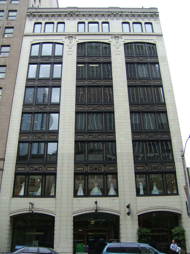 The Holland Building now known as the Miken Building as shown here in 2017 is  located mid-block on the west side of Fourth Avenue  between Union and Pike Streets in Seattle Wa., this  eight-story office building was designed and constructed in two phases with the initial four floors built in 1918 and the upper four floors added in 1923. It is assumed that the building was built and expanded for The Exeter Company. The 1923 addition was constructed according to plans prepared by architects Stuart and Wheatley.  In L.A. Martins Order book for the Columbia Terra Cotta it is order #102 Glaze 99, the Holland Building Seattle Wa. Arcitects Stewart+Wheatley.  According to an article July 7th, 1923 in the Vancouver Columbian: "With 40 percent of the moulds necessary for their first contract already completed,, work at the Columbia Terra Cotta Company plant, at the foot of west 13th street is progressing so rapidly that Manager M. L. Bryan declared today his company expects to start burning its first kiln of terra cotta by the latter part of the week. ... The job consists of all the terra cotta work for the eight-story Holland building now under construction at Fourth avenue and Pike street in Seattle. ... Bryan says "it si a good contract and, with the exception of a few pieces, the design is not particularly complicated ..." ..."The contract specifies cream colored, glazed terra cotta.  The contract specifies the first delivery must begin by September 22 ..."