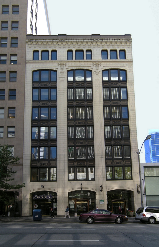 The Holland Building now known as the Miken Building as shown here in 2017 is  located mid-block on the west side of Fourth Avenue  between Union and Pike Streets in Seattle Wa., this  eight-story office building was designed and constructed in two phases with the initial four floors built in 1918 and the upper four floors added in 1923. It is assumed that the building was built and expanded for The Exeter Company. The 1923 addition was constructed according to plans prepared by architects Stuart and Wheatley.  In L.A. Martins Order book for the Columbia Terra Cotta it is order #102 Glaze 99, the Holland Building Seattle Wa. Arcitects Stewart+Wheatley.  According to an article July 7th, 1923 in the Vancouver Columbian: "With 40 percent of the moulds necessary for their first contract already completed,, work at the Columbia Terra Cotta Company plant, at the foot of west 13th street is progressing so rapidly that Manager M. L. Bryan declared today his company expects to start burning its first kiln of terra cotta by the latter part of the week. ... The job consists of all the terra cotta work for the eight-story Holland building now under construction at Fourth avenue and Pike street in Seattle. ... Bryan says "it si a good contract and, with the exception of a few pieces, the design is not particularly complicated ..." ..."The contract specifies cream colored, glazed terra cotta.  The contract specifies the first delivery must begin by September 22 ..."