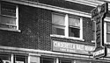 This photo shows both the Barnes building, (on the corner with the Drug store and hardware store in it), and the Lotus Building adjoining it with contiguous brick and terra cotta work. Columbia Terra Cotta Company Order# 111.